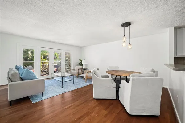 a living room with furniture and a wooden floor
