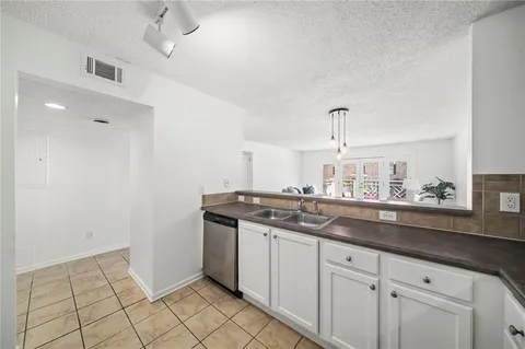 a kitchen with a sink and cabinets