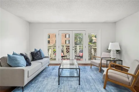 a living room with furniture and wooden floor