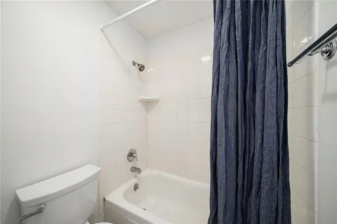 a white bath tub sitting next to a white toilet