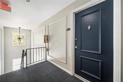 a view of a hallway with entryway door