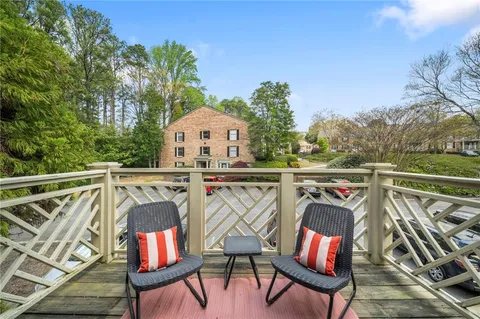 a view of deck with furniture and trees