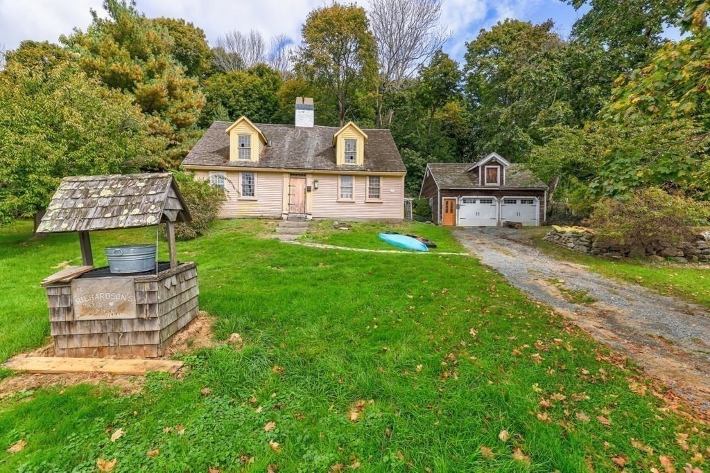 116 Spring Street Hull, MA 02045 - Photo 12 of 37 a front view of a house with a garden and plants