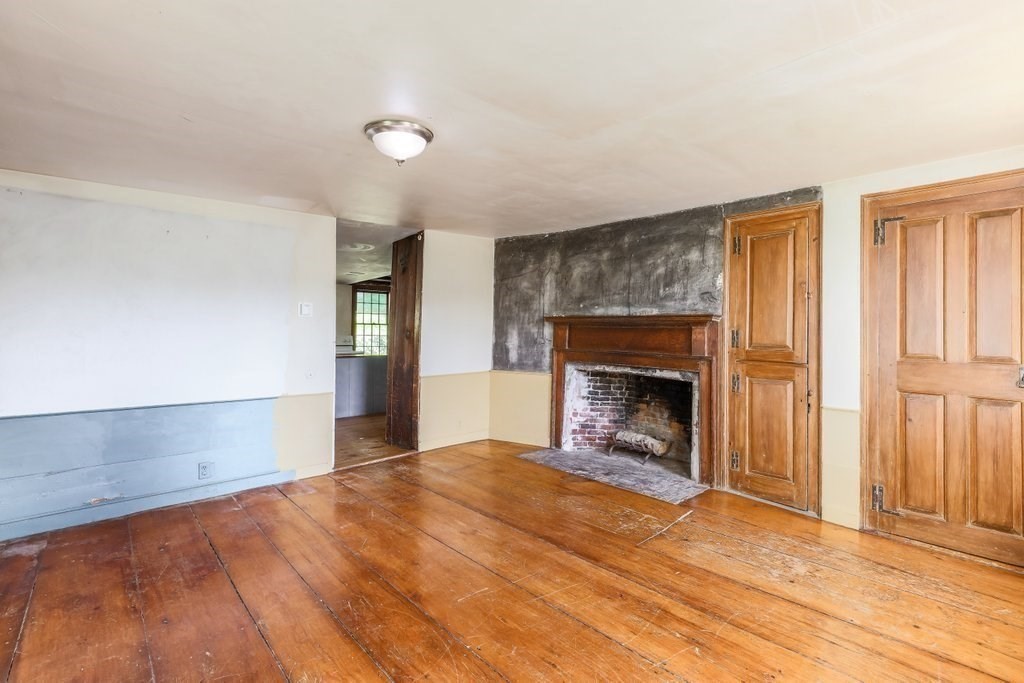 116 Spring Street Hull, MA 02045 - Photo 14 of 37 a view of an empty room with window and fire place