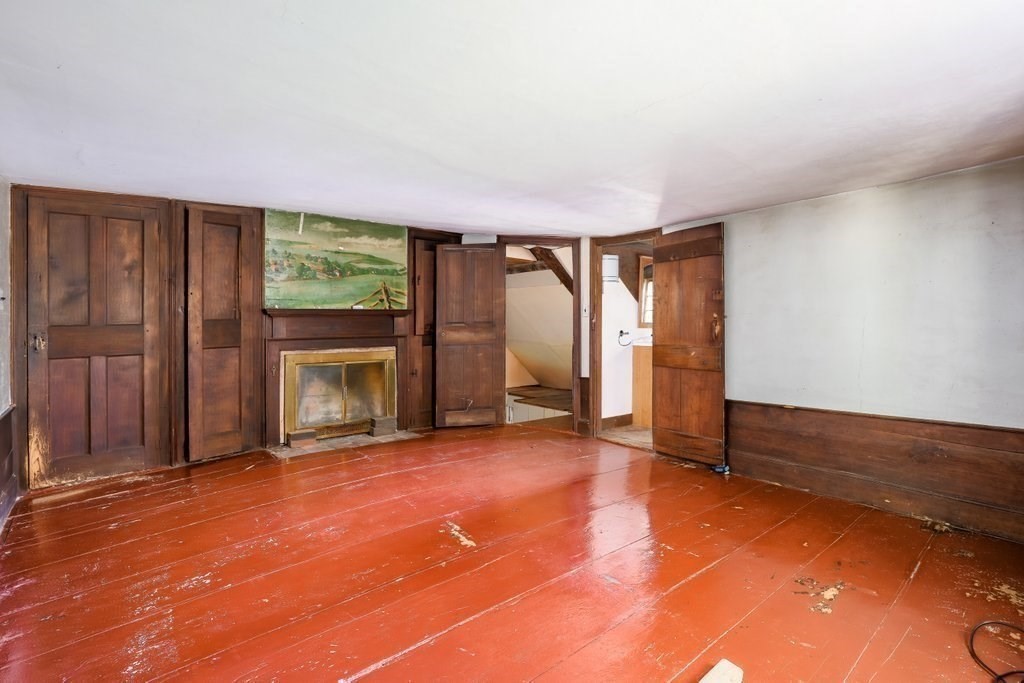 116 Spring Street Hull, MA 02045 - Photo 23 of 37 an empty room with windows fireplace and a ceiling fan