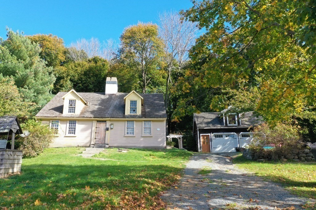 116 Spring Street Hull, MA 02045 - Photo 27 of 37 a front view of a house with a garden and tree