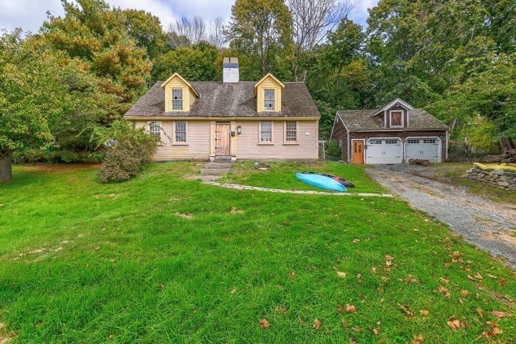 116 Spring Street Hull, MA 02045 - Photo 6 of 37 a front view of a house with a yard and garage