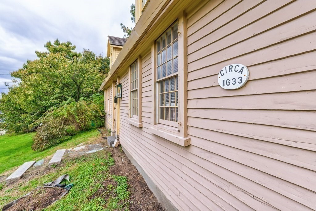 116 Spring Street Hull, MA 02045 - Photo 9 of 37 a view of a door with wooden floor and fence and yard