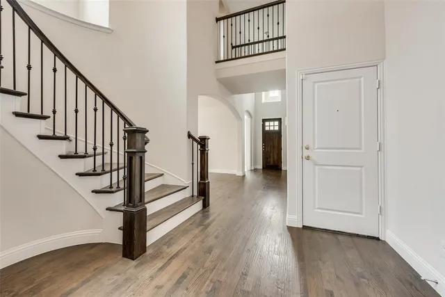 a view of entryway with wooden floor and stairs