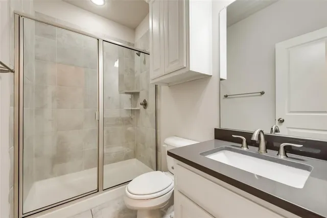 a bathroom with a sink toilet and shower