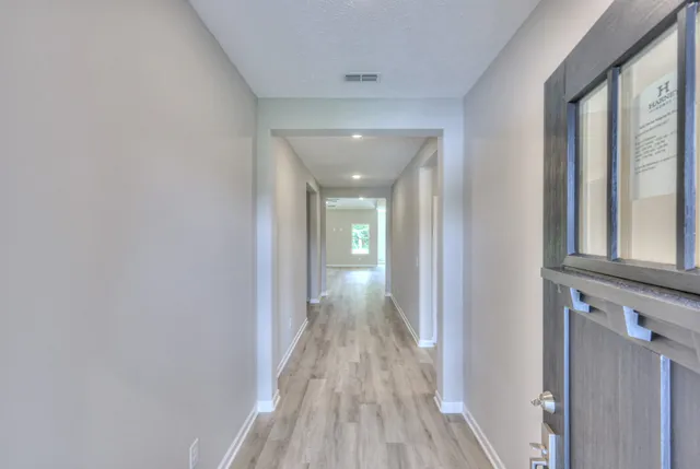 a view of hallway with wooden floor