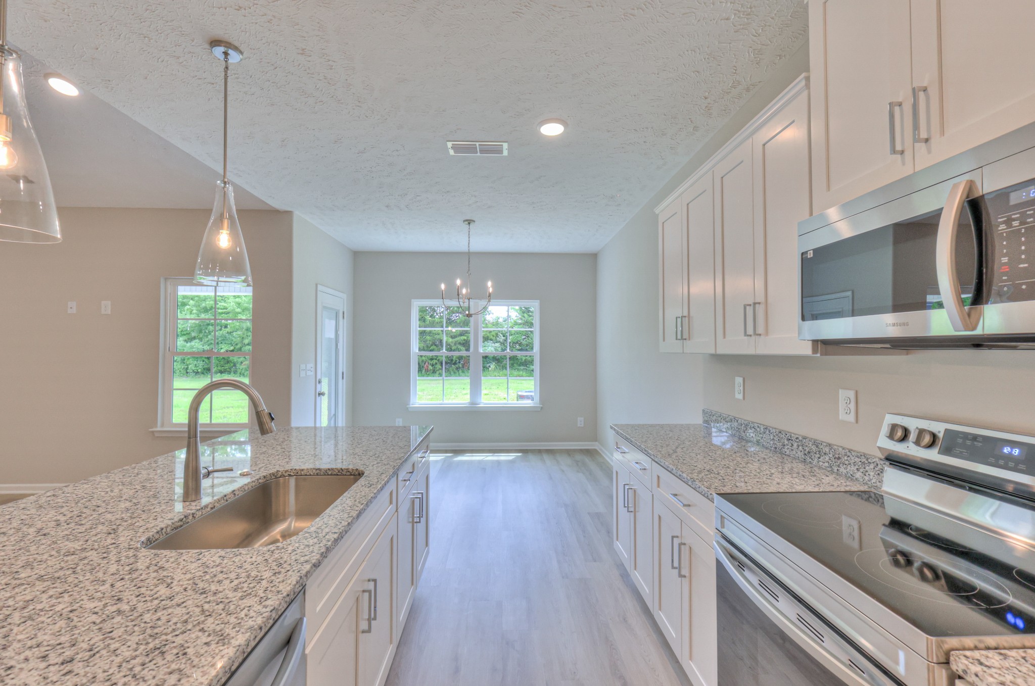 18 North Fork Branch Road Normandy, TN 37360 - Photo 10 of 28 a kitchen with kitchen island granite countertop a sink a counter space appliances and cabinets