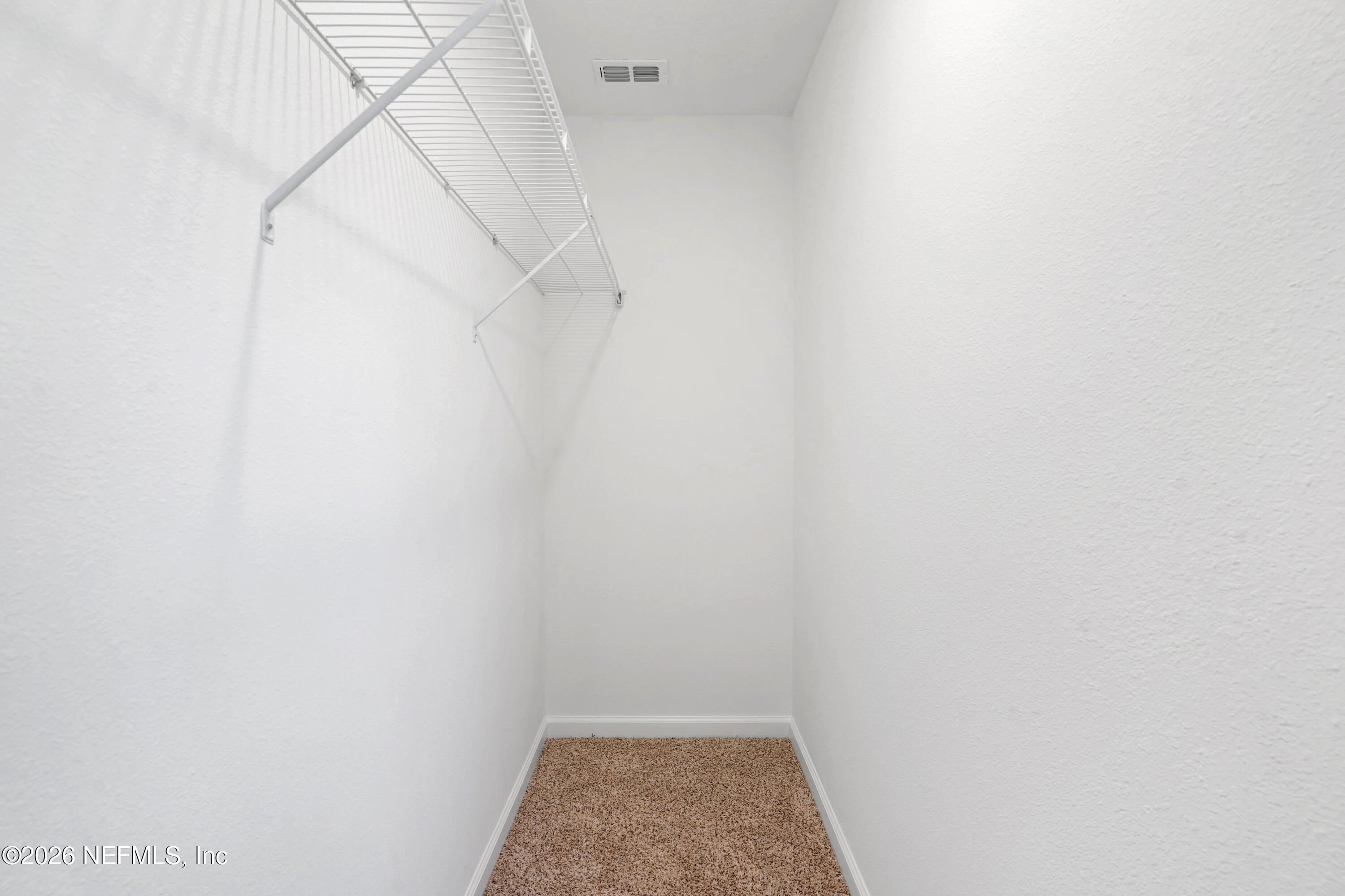 131 Palmetto Rdg Road St. Augustine, FL 32095 - Photo 15 of 26 a view of walk in closet with racks on the wall
