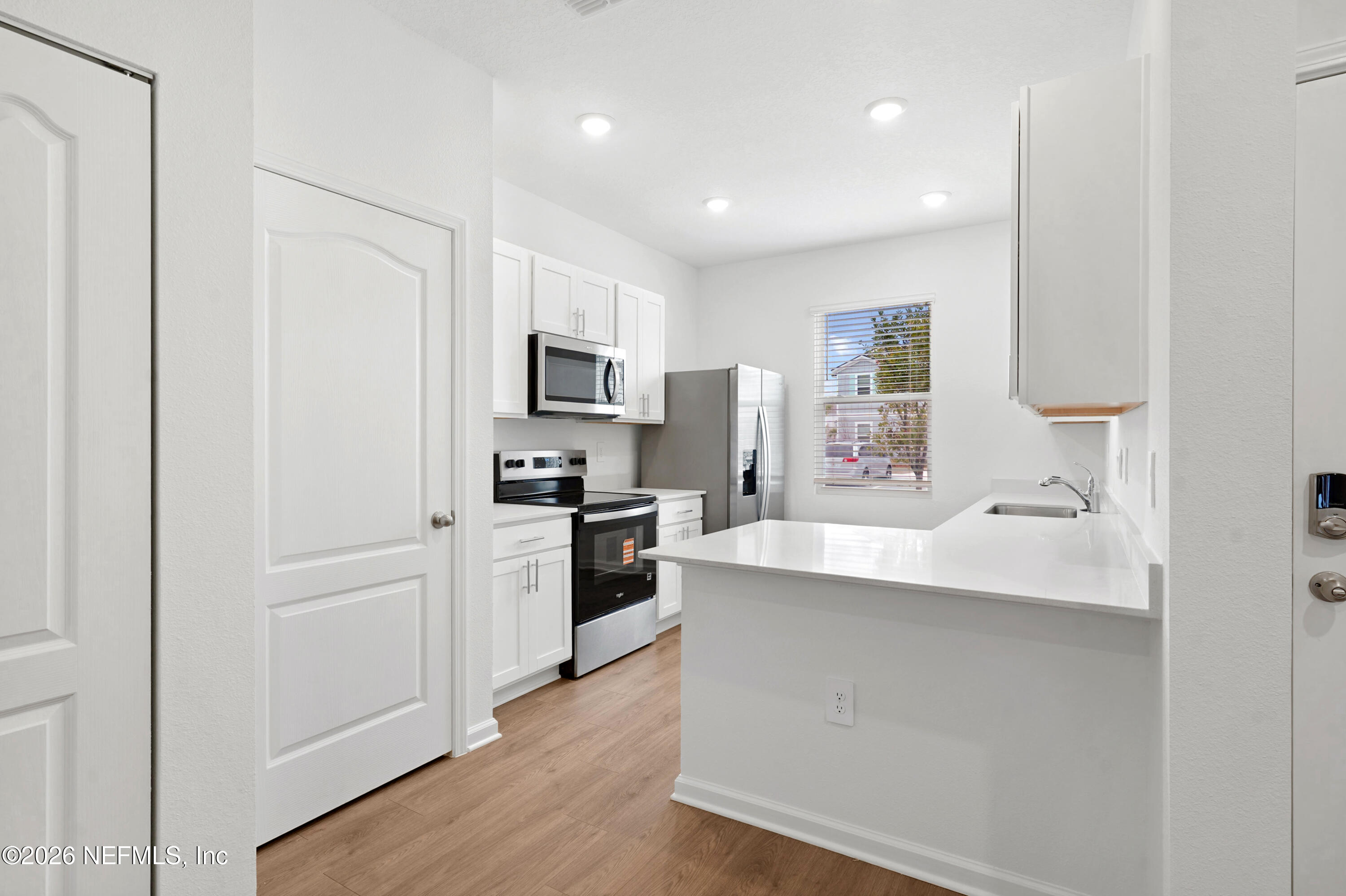 131 Palmetto Rdg Road St. Augustine, FL 32095 - Photo 3 of 26 a kitchen with cabinets stainless steel appliances a sink and a refrigerator