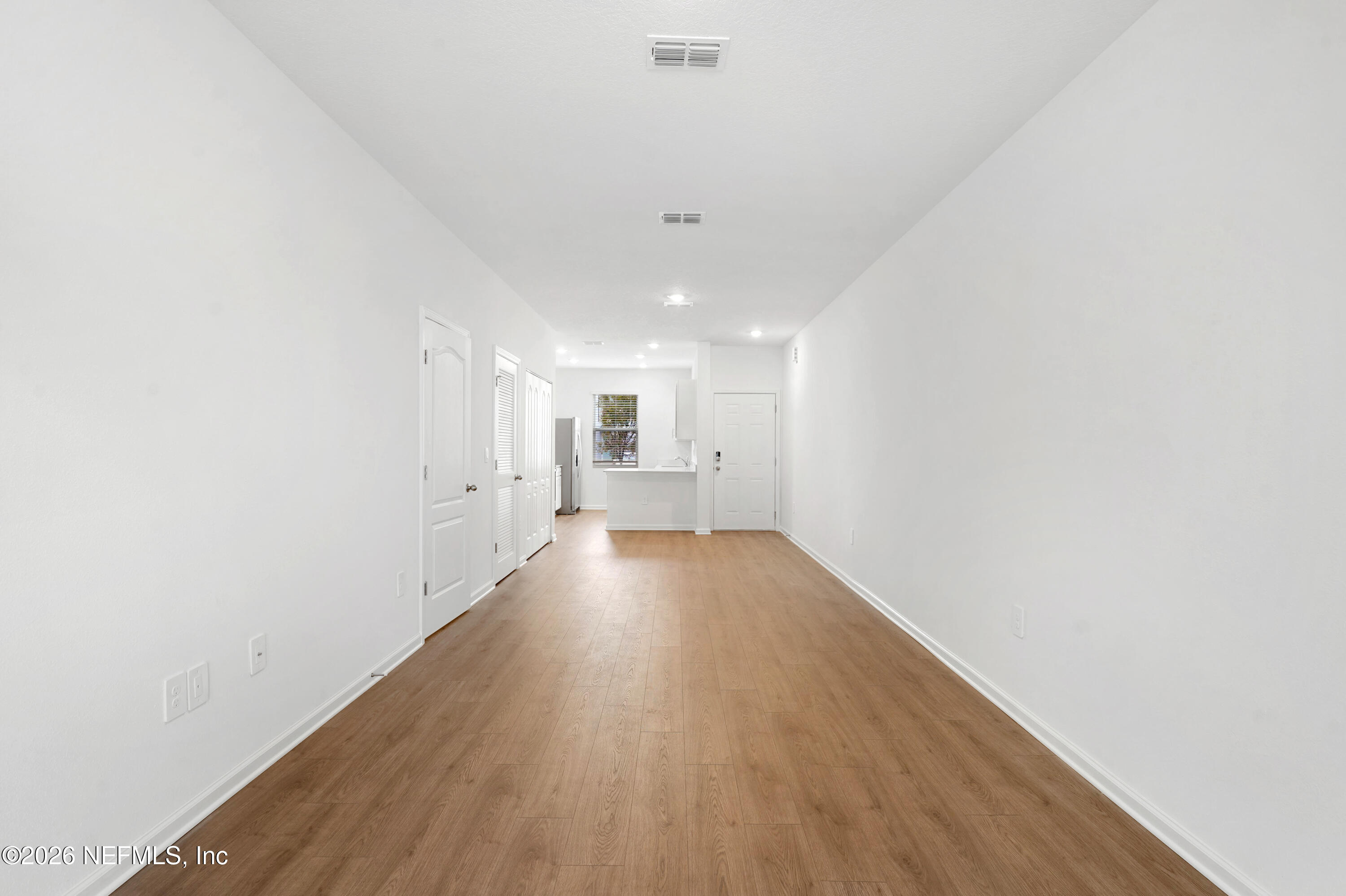 131 Palmetto Rdg Road St. Augustine, FL 32095 - Photo 9 of 26 a view of a hallway with wooden floor