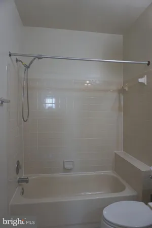 a bathroom with a shower and toilet