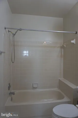 a bathroom with a shower and toilet