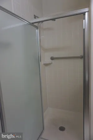 a bathroom with a glass shower door