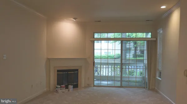 a view of an empty room with a fireplace