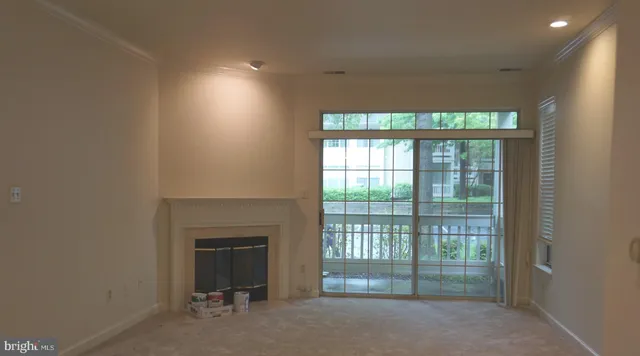 a view of an empty room with a fireplace