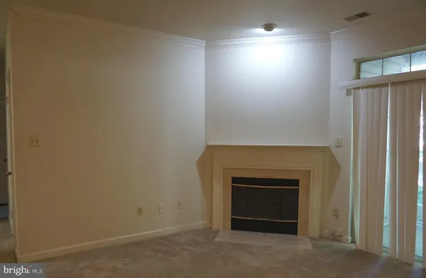 an empty room with a fireplace