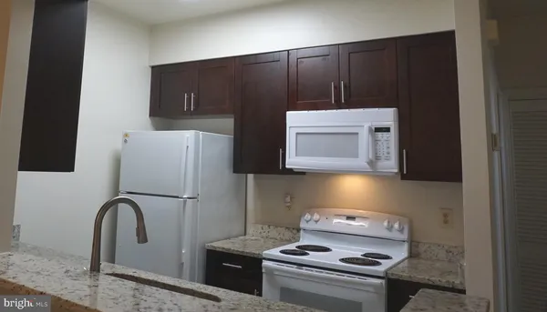 a kitchen with a refrigerator and a stove