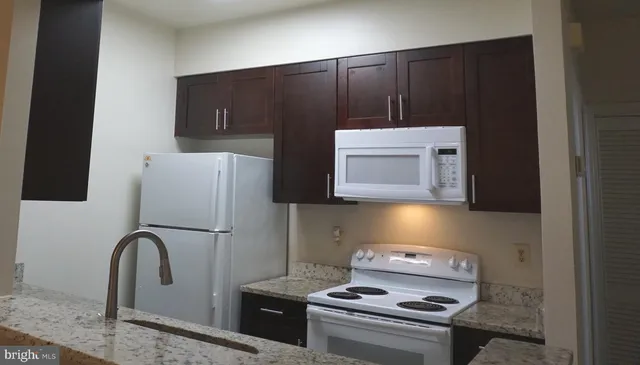 a kitchen with a refrigerator and a stove