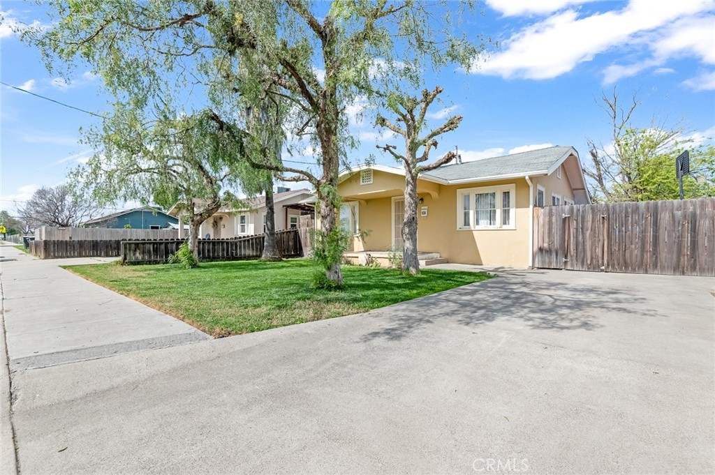 414 West Cameron Street Hanford, CA 93230 - Photo 2 of 12 a view of a white house with a big yard and large trees