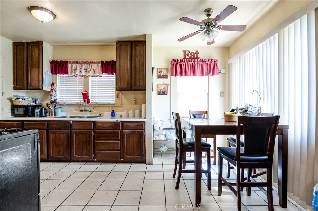 414 West Cameron Street Hanford, CA 93230 - Photo 6 of 12 a kitchen with a sink dining table and chairs