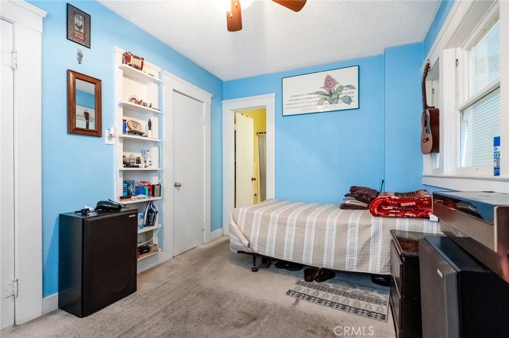 414 West Cameron Street Hanford, CA 93230 - Photo 8 of 12 a bedroom with a bed and cabinets
