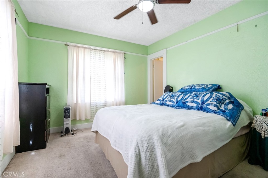414 West Cameron Street Hanford, CA 93230 - Photo 10 of 12 a bedroom with a bed and a chandelier