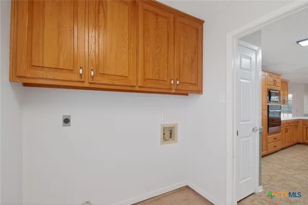 an empty room with fan and entrance