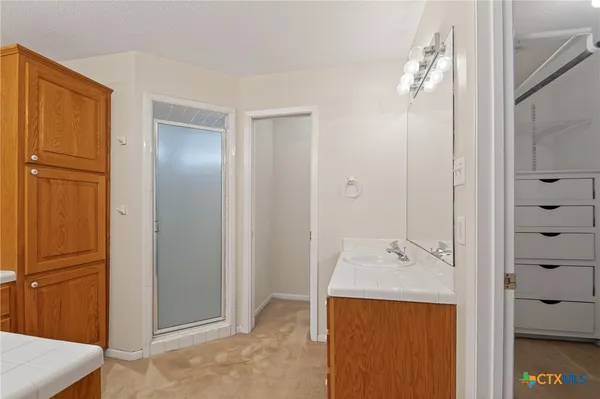 a bathroom with a double vanity sink and mirror