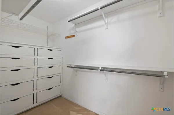 an empty room with a ceiling fan and a window