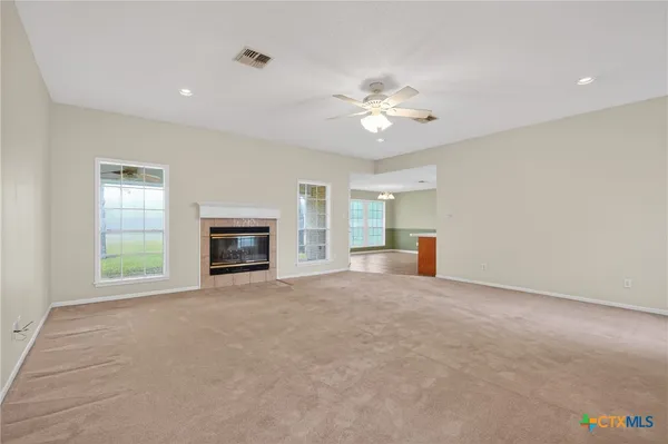 a large white kitchen with a large window