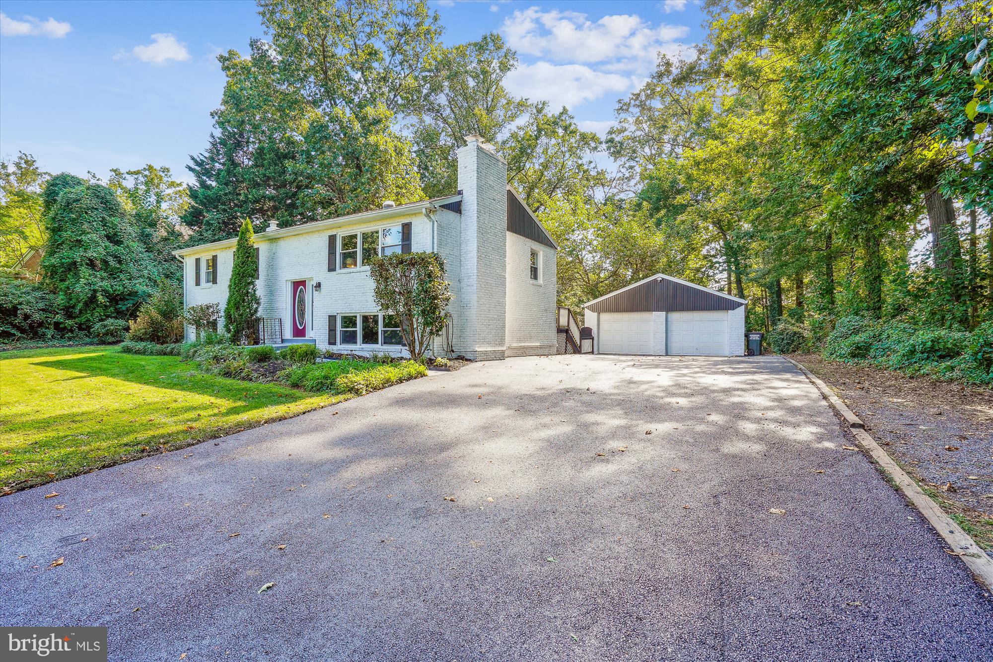 5742 Rolling Road Burke, VA 22015 - Photo 15 of 53 a front view of a house with a yard and garage