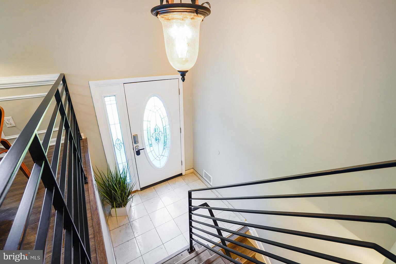 5742 Rolling Road Burke, VA 22015 - Photo 17 of 53 a view of a hallway with wooden floor and glass door