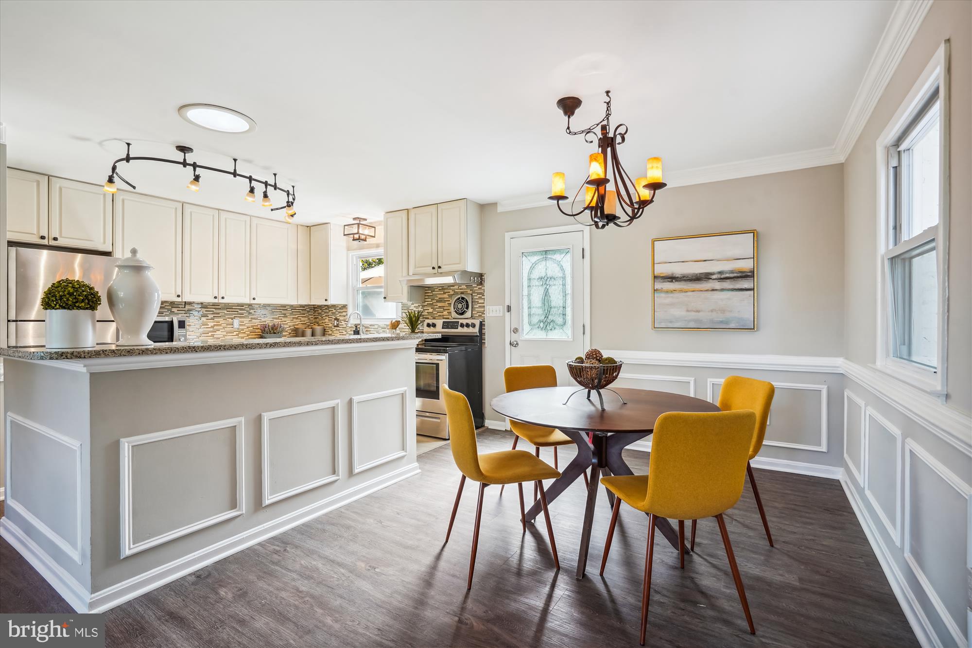 5742 Rolling Road Burke, VA 22015 - Photo 24 of 53 a kitchen with stainless steel appliances kitchen island granite countertop a dining table chairs and granite counter tops