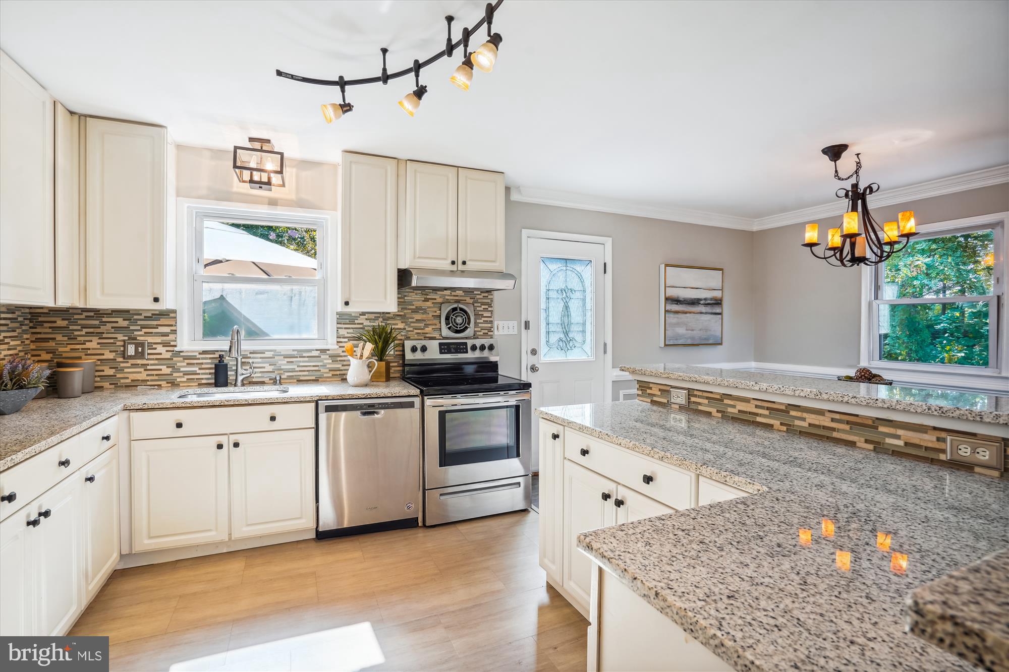 5742 Rolling Road Burke, VA 22015 - Photo 25 of 53 a kitchen with stainless steel appliances granite countertop a stove a sink and a refrigerator