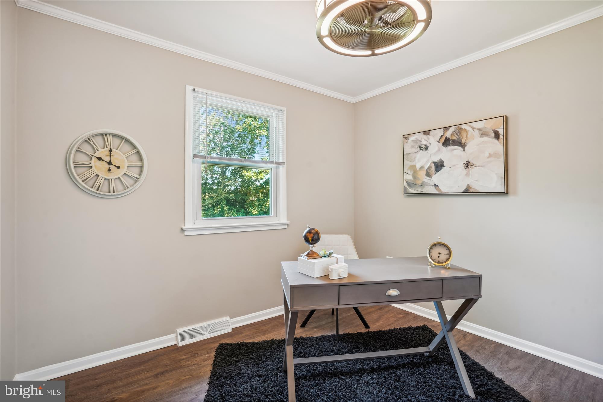 5742 Rolling Road Burke, VA 22015 - Photo 36 of 53 a view of a workspace with a table and chair in a room