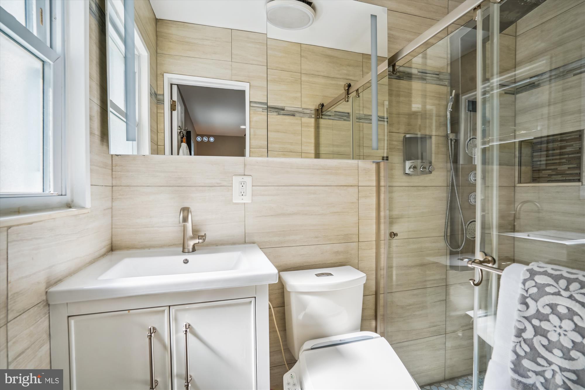 5742 Rolling Road Burke, VA 22015 - Photo 44 of 53 a bathroom with a sink toilet and shower