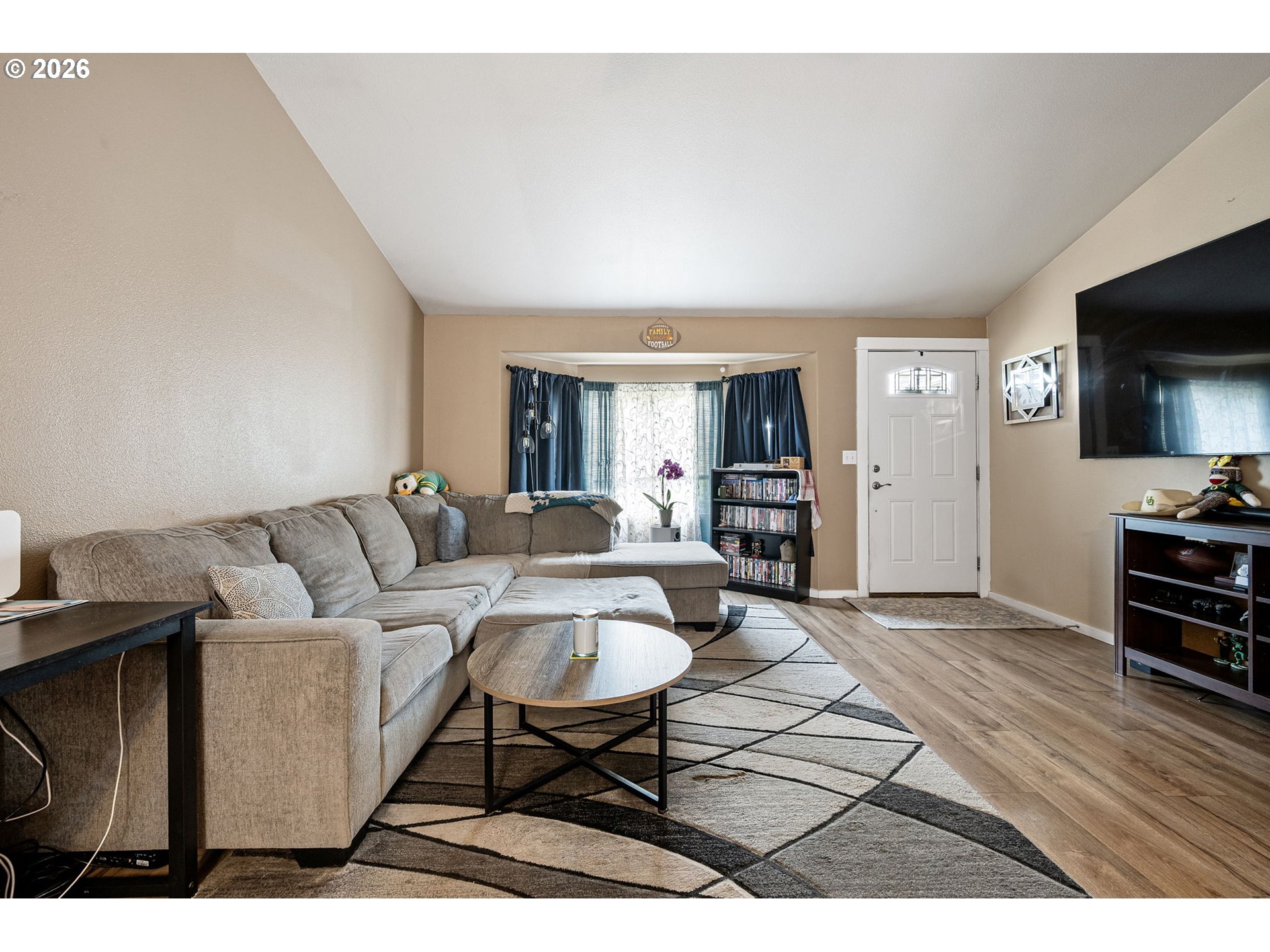 1055 Ash Grove Loop Creswell, OR 97426 - Photo 7 of 33 a living room with furniture a flat screen tv and kitchen view