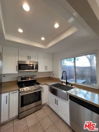 a kitchen that has a sink and a stove