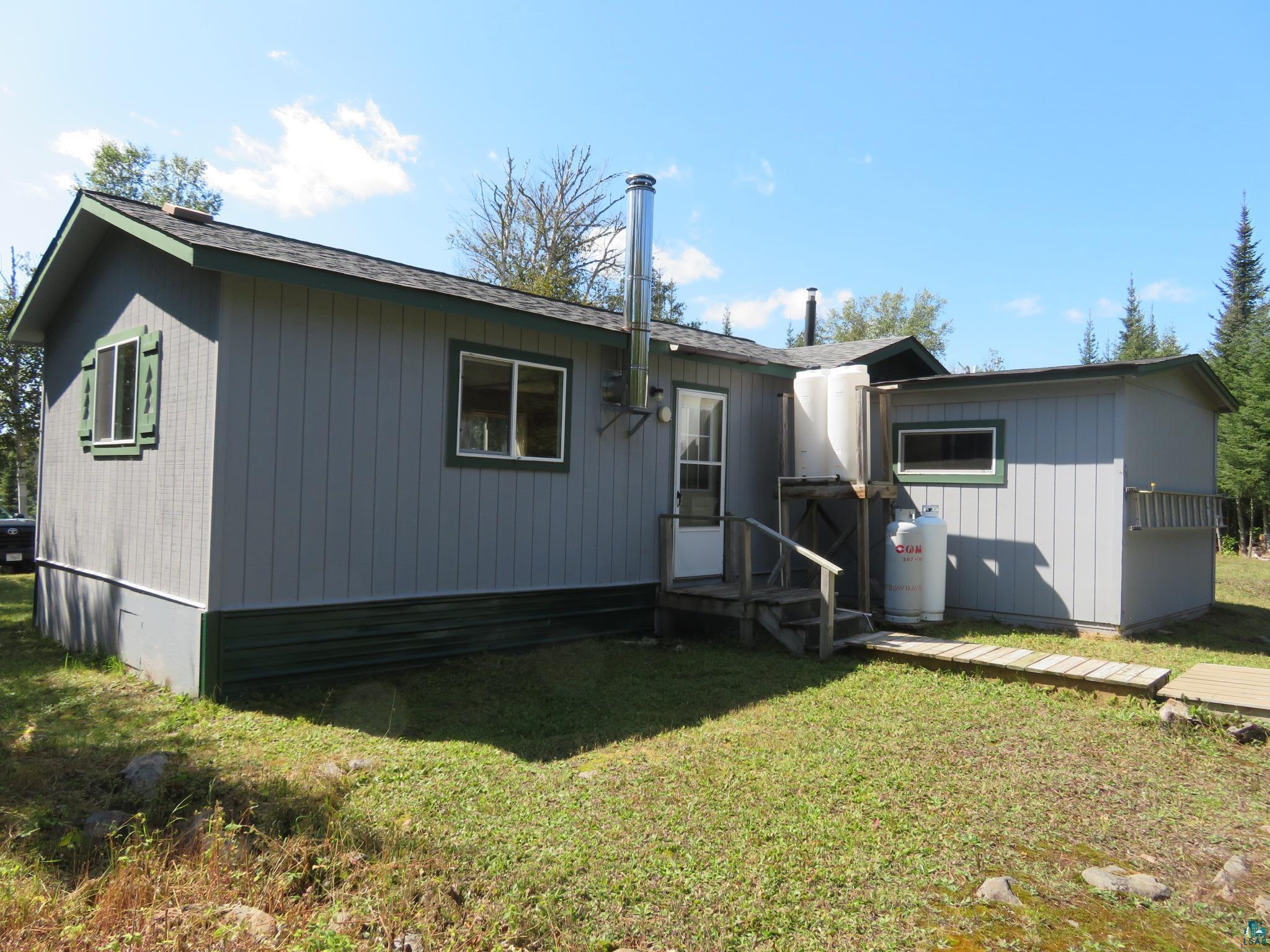 1268 Tom Lake Road Hovland, MN 55606 - Photo 38 of 56 Rear view of property with a yard