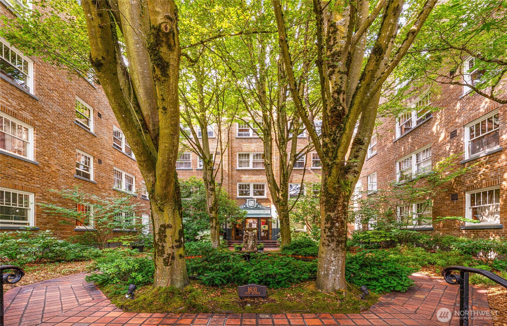 1631 16th Avenue Seattle, WA 98122 - Photo 1 of 1 a large tree in front of a brick house