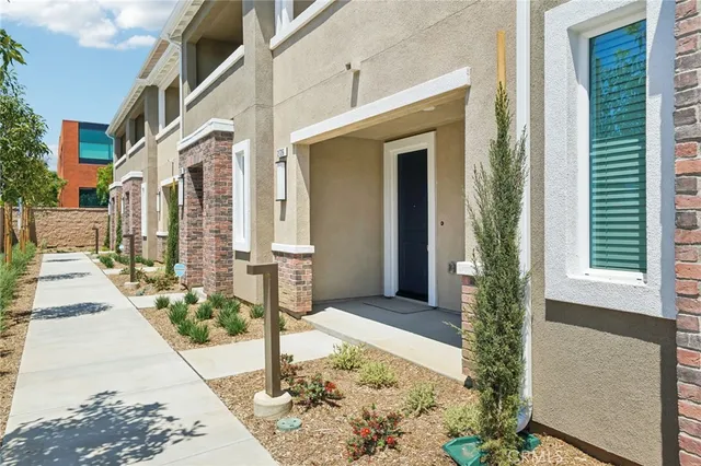 a view of a brick house with many windows