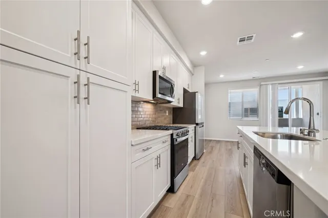 a kitchen with a sink stove and refrigerator