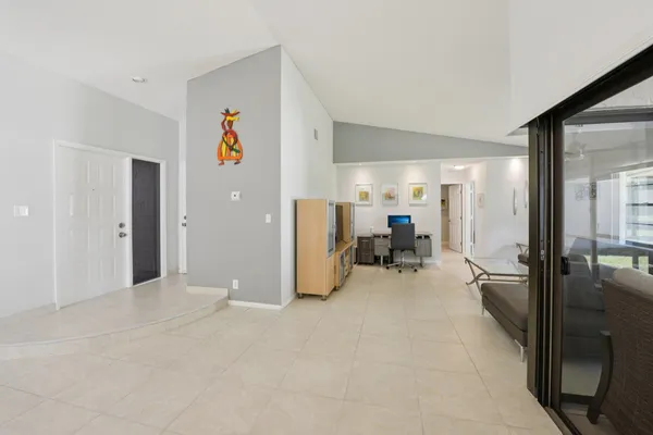 a bedroom with a large white bed and a large window
