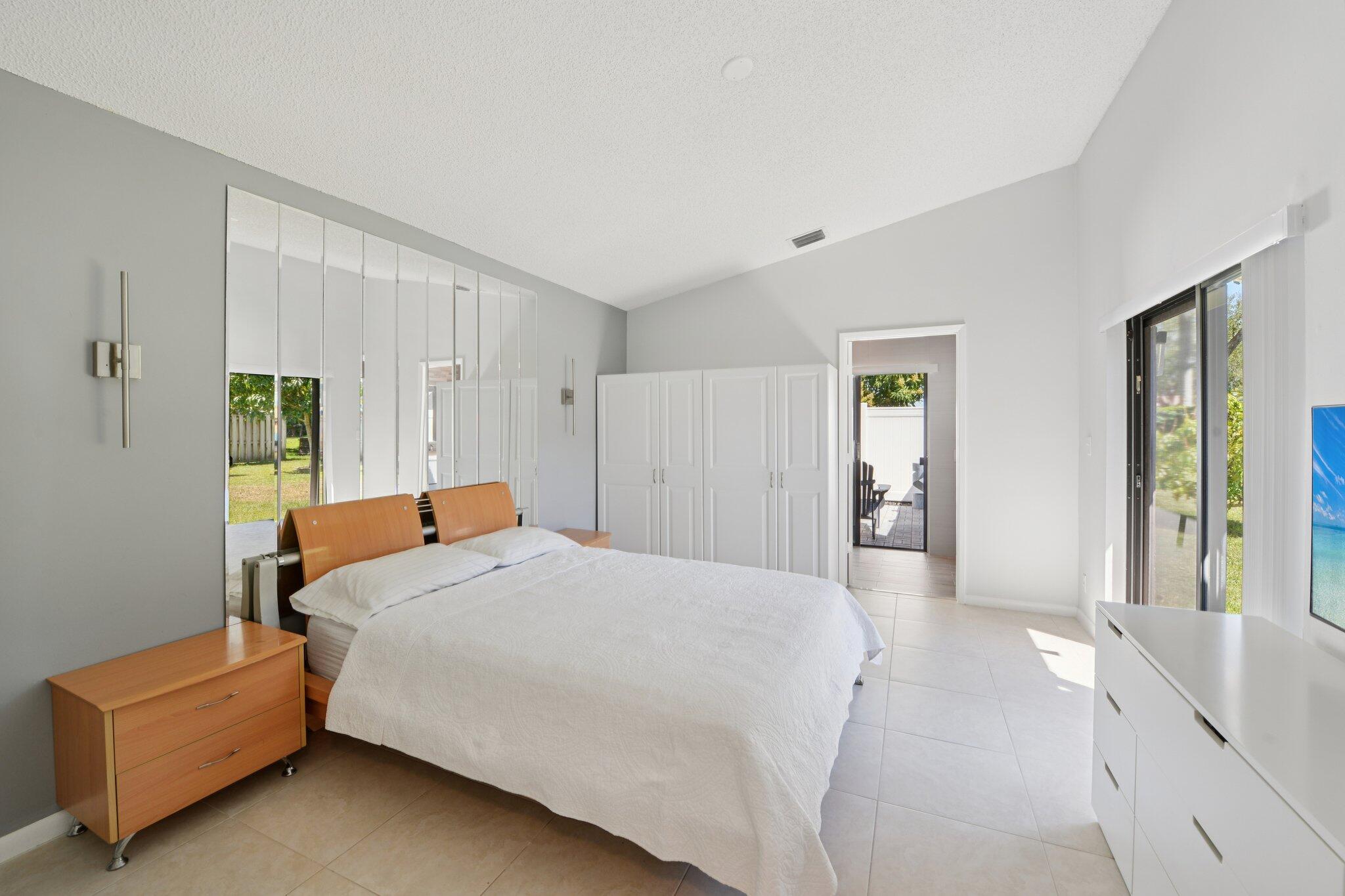 21024 Country Creek Drive Boca Raton, FL 33428 - Photo 15 of 59 a bedroom with a bed and a couch