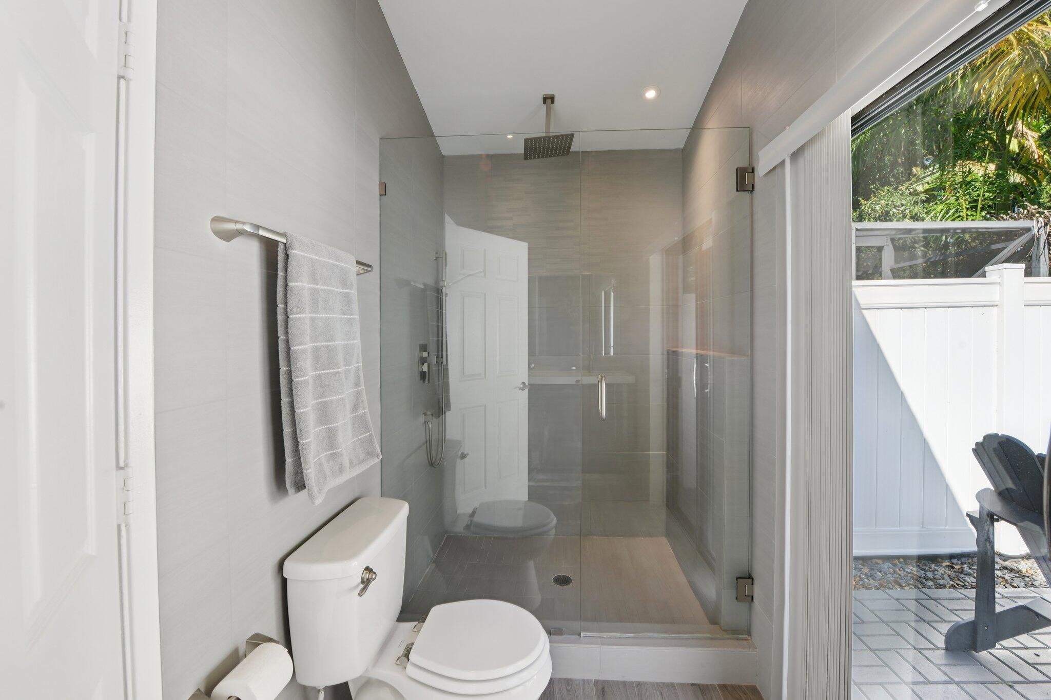 21024 Country Creek Drive Boca Raton, FL 33428 - Photo 18 of 59 a bathroom with a shower a toilet and a sink